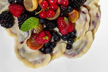 Dumplings with raspberries, kumquats, blackberries