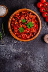 Chili Con Carne in bowl on dark background.