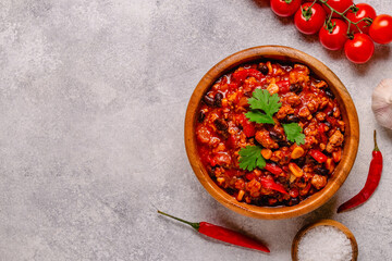 Chili Con Carne in bowl on grey background.