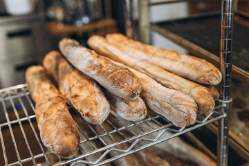 Fresh tasty Baguettes on bakery shelves. Concept of french delicious food