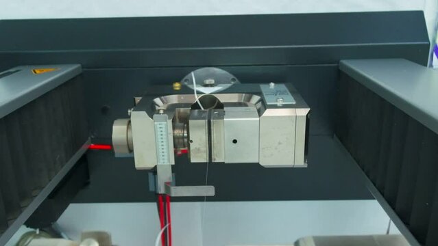 Polymer thread for plastic sack bags is tested for strength in laboratory, slow motion