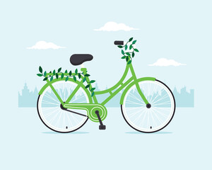 Fototapeta na wymiar Green bicycle with green leaves in the city. Eco friendly vehicle concept. 