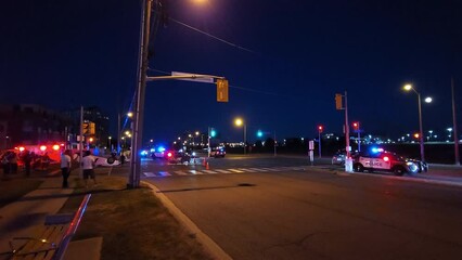 People watching emergency services clearing wreckage after a multi car accident