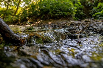 Water running in a stream close-up. Soft focus