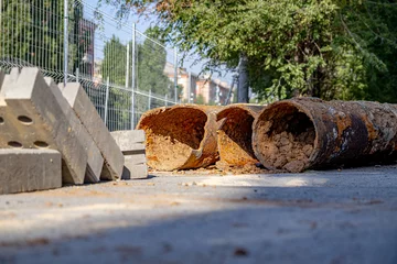 Foto op Plexiglas Old rusty pipes extracted from the ground during the repair of the city water main. Soft focus ©   AAA
