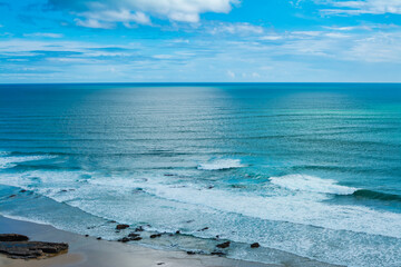 Picturesque ocean landscape. Sea waves and beautiful sky with white clouds