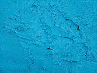 Beautiful blue abstract wall background in a cool mood. Textured wall with blue paint.