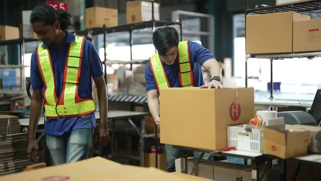 In the warehouse storage areawarehouse staff pulling manual pallet hand truck carry stacking box to cashier counter for payment
