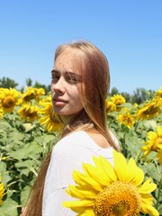 Young girl dabbles in sunflowers