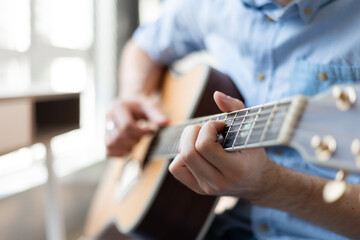 Close up of man hand playing acoustic guitar..