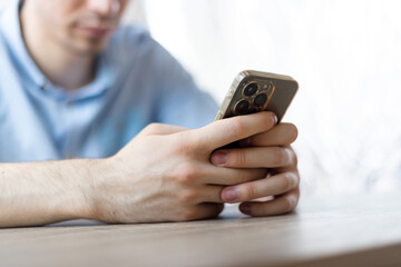 Man with a finger on the screen using a mobile phone in the office.