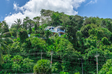 Villa Mansion in Phuket Mountains over looking Karon Beach lovely Skies Sunset over  Patong Pa Tong Beach in Phuket island Thailand. Lovely lush green mountains colourful skies