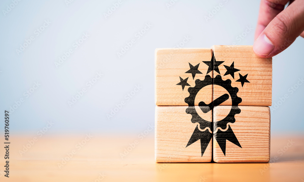 Poster businessman holding wooden cube block which print screen the best quality assurance with five stars 