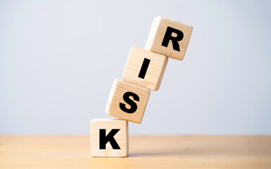Risk wording print screen on wooden cube block and falling on the table for risk analysis and...