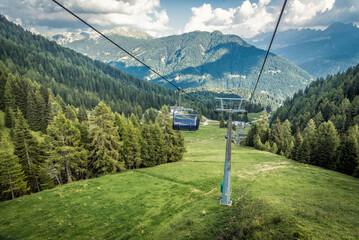 gondola ski lift in mountain ski resort, green forest © nickolya
