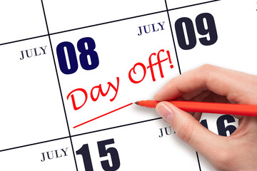 Hand writing text DAY OFF and drawing a line on calendar date 8 July. Vacation planning concept.