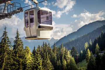 gondola ski lift in mountain ski resort, green forest