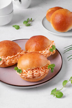 Brioche buns with yam cream with cream cheese on the white table. Sweet potato dessert