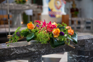 Bridal Impressions, colorful floral decoration at the altar during the wedding ceremony at the church. High quality photo