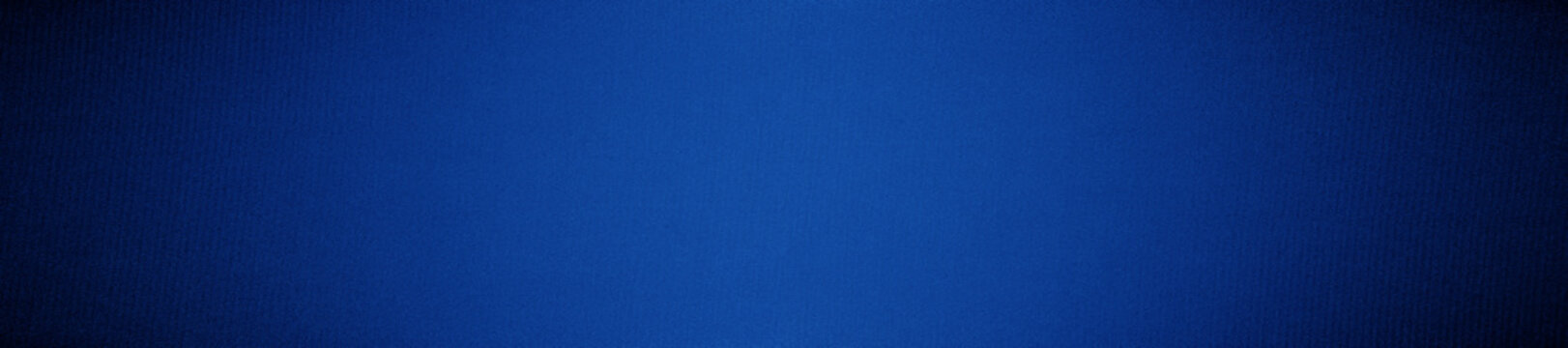 Dark blue background with a light spot. Gradient. Deep blue background with space for design. Web banner. Wide. Panoramic. Website header.