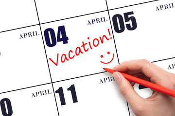 A hand writing a VACATION text and drawing a smiling face on a calendar date 4 April. Vacation...