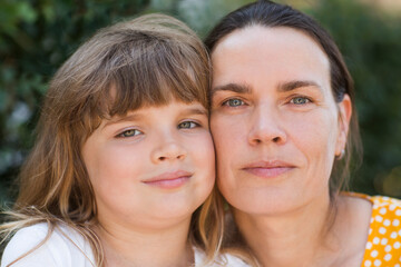 Fototapeta premium portrait of mother and little daughter in nature on a summer day. Happy family