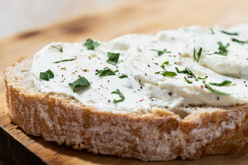 Cream cheese toast on cutting board. Close up