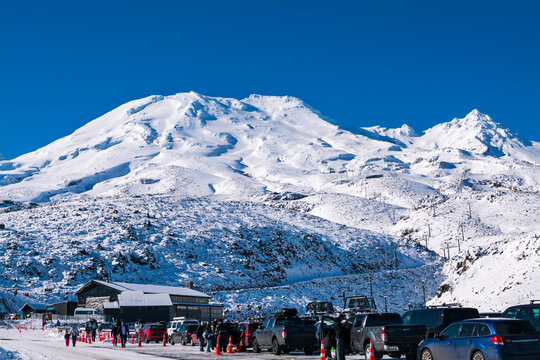 Busy ski resort in winter mountains. Turoa ski field at Mt Ruapehu, New Zealand. Beautiful mountains and the blue sky, winter landscape