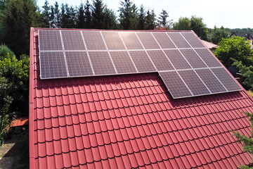 Photovoltaic panels on the roof of a country house from a bird's eye view