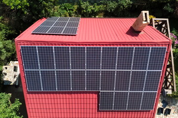 Photovoltaic panels on the roof of a country house from a bird's eye view