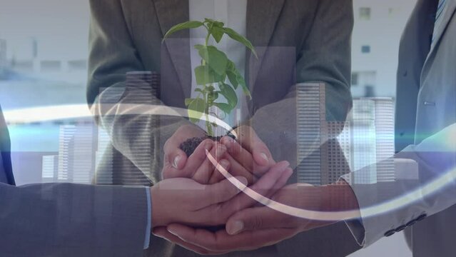 Animation of light trails over mid section of three businessmen holding a plant sampling