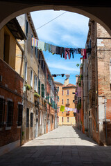Washing are being dried hung on clotheslines in the streets of ancient Venice
