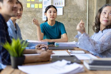 Business team meeting to discuss business marketing strategy planning while employees watch new project presentations.