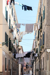 Fototapeta na wymiar Washing are being dried hung on clotheslines in the streets of ancient Venice