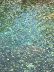 Sea glittering clear water surface in paradise turquoise lagoon.