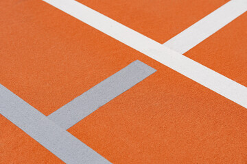Fototapeta premium Unusual orange tennis court with white lines and light gray pickleball lines 