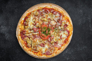 Four meat pizza on a wooden board on gray concrete. top view