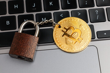 No Bitcoin or Cryptocurrency. Padlock and bitcoin on keyboard