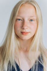 Naklejka premium Young blondie caucasian girl on white background. Natural beauty, no make up, casual lifestyle girl. Young face