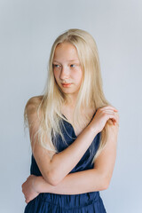 Young blondie caucasian girl on white background. Natural beauty, no make up, casual lifestyle girl. Young face