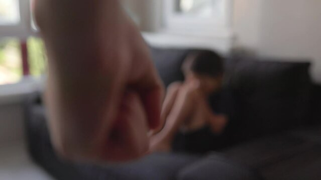 Clenched fist against the background of a crying woman. domestic violence concept
