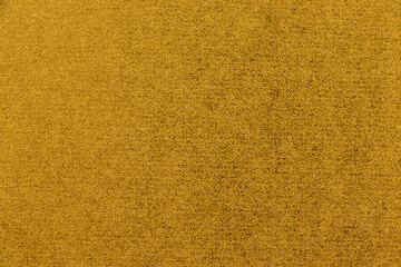 細かな凹凸のある金色の壁紙