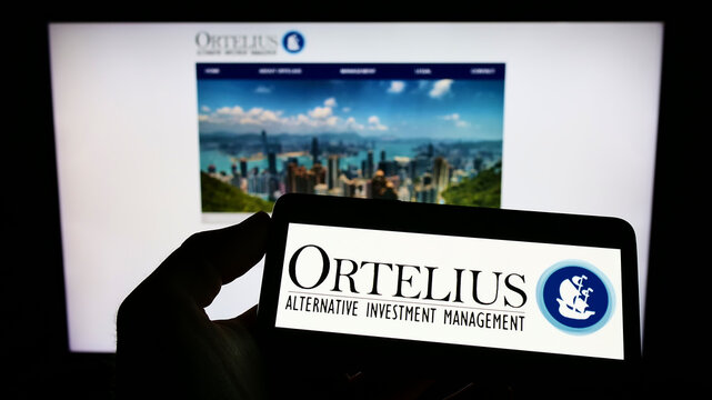 Stuttgart, Germany - 07-24-2022: Person holding cellphone with logo of US hedge fund company Ortelius Advisors LP on screen in front of business webpage. Focus on phone display.