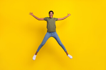 Fototapeta na wymiar Full size photo of excited active person jump make star figure isolated on yellow color background