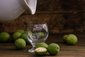 green walnut kernels leaves  wooden table oil nuts unripe husks healthy food drink, old rustic table Background Harvest, organic Homemade plant based milk Dairy free  jug glass cup