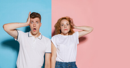 Portrait of young emotive couple posing with shocked expression isolated over pink blue studio...