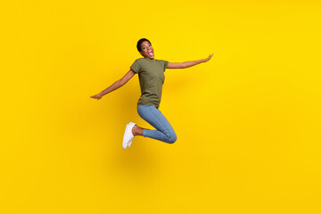 Fototapeta na wymiar Full body photo of overjoyed person jump fly have good mood isolated on yellow color background
