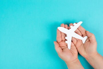 Holding an airplane in the hands, taking a flight, planning a vacation
