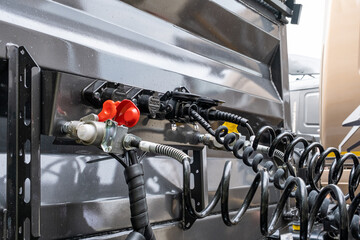 Pneumatic pumping hoses and connections of the body with the trailer to the truck. Closeup of...