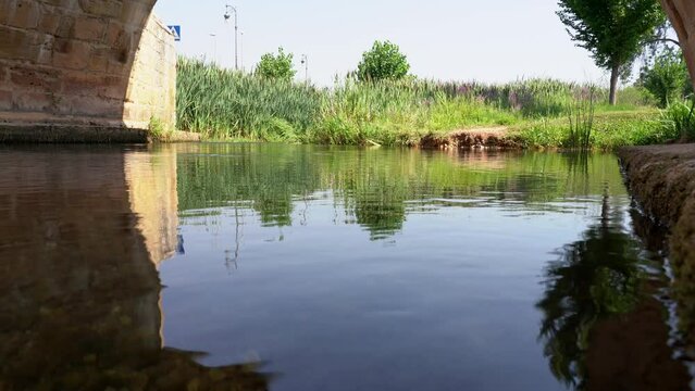 River Ucero passing under the medieval bridge that gives entrance to the old city of Burgo de Osma.